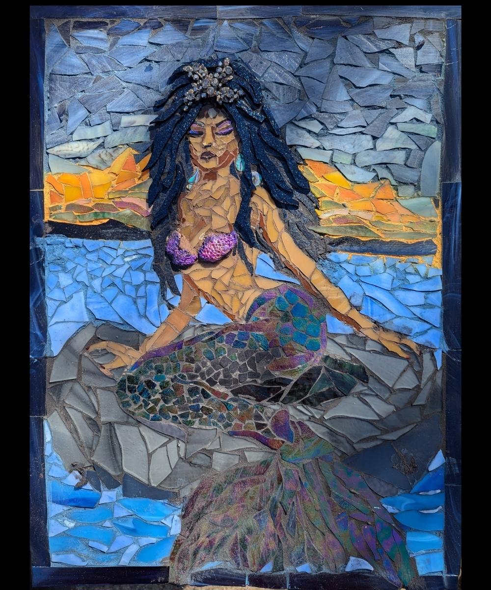 Mother of the Waters – Stained Glass Mosaic by Alicia Taylor Low | Rooted in Radiance Collection Mother of the Waters – Stained Glass Mosaic by Alicia Taylor Low<br />
A spiritual stained glass mosaic of a mermaid-like figure immersed in oceanic blues and greens, with flowing glass, gemstones, and shimmering textures. Made with hand-cut stained glass, beads, and soulful findings, this piece honors grief, intuition, and the sacred feminine. Part of the Rooted in Radiance Solstice collection.