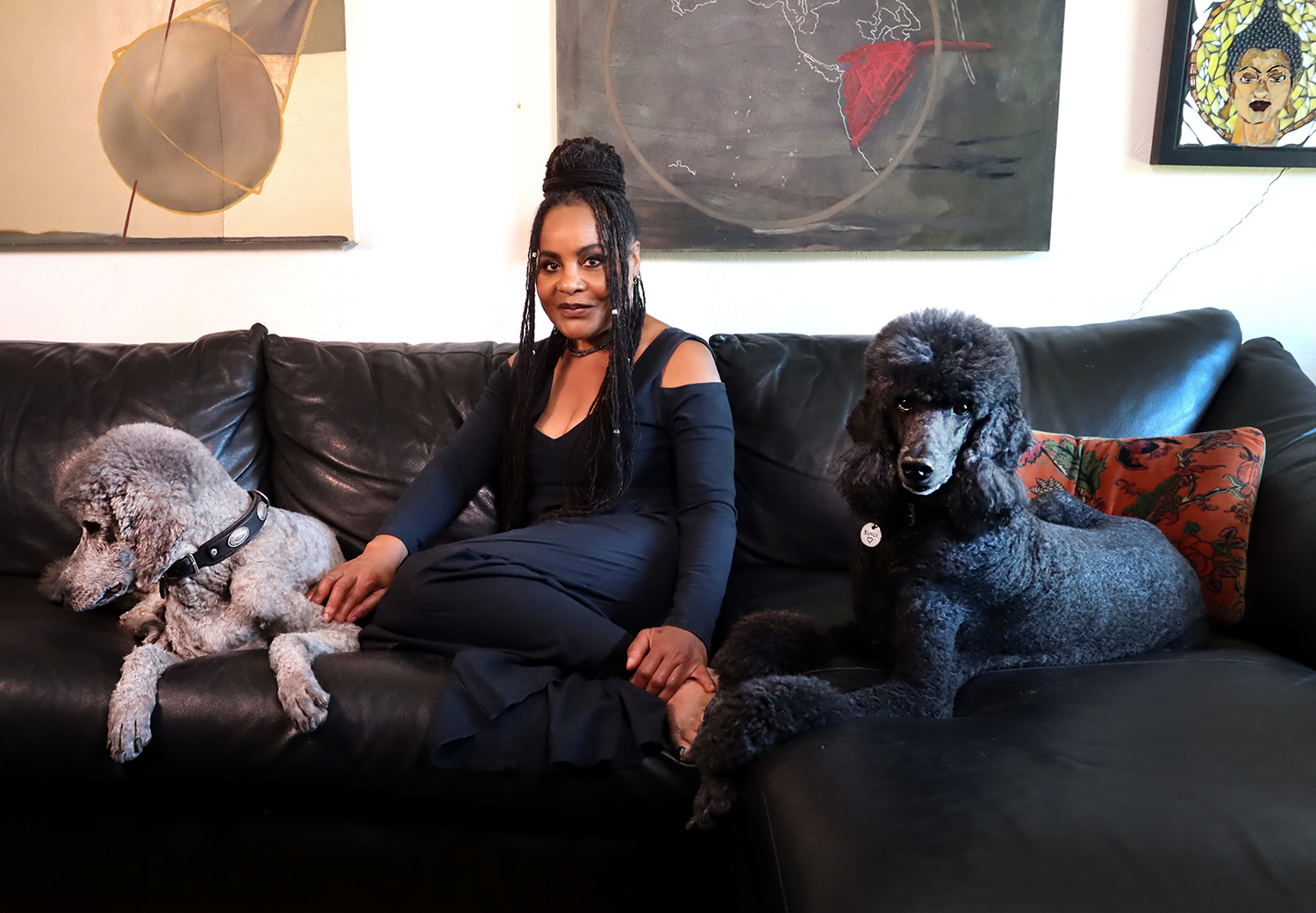 Alicia- dos Doggies_X Alicia Taylor Low, mosaic artist, smiling outdoors with two small white poodles in her lap — representing her connection to pets, nature, and soulful custom art.